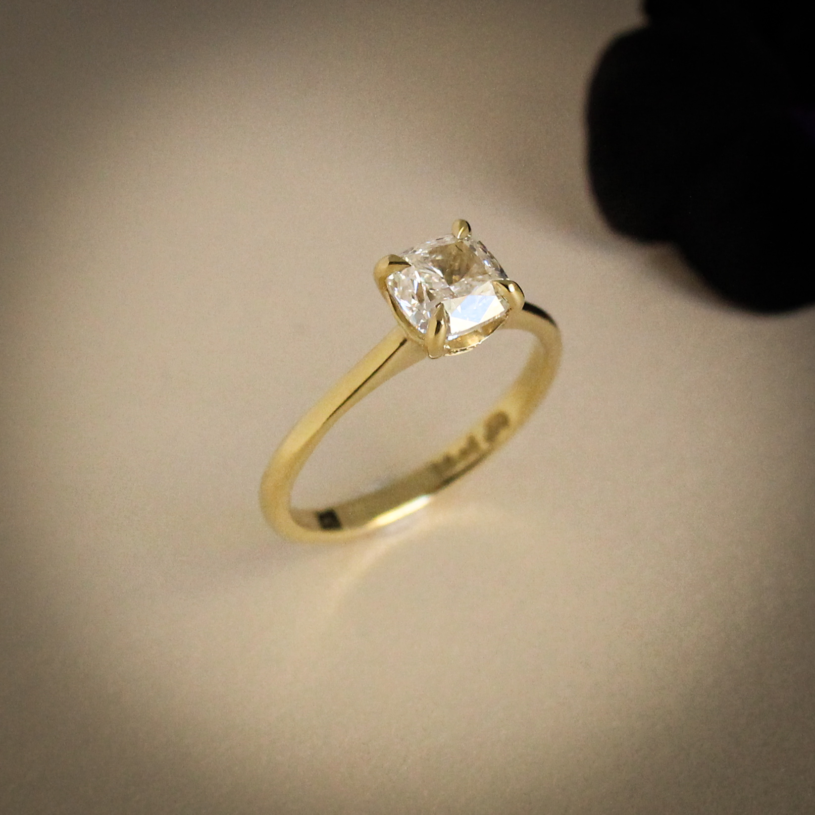 1ct cushion cut diamond engagement ring in yellow gold with hidden emerald detail