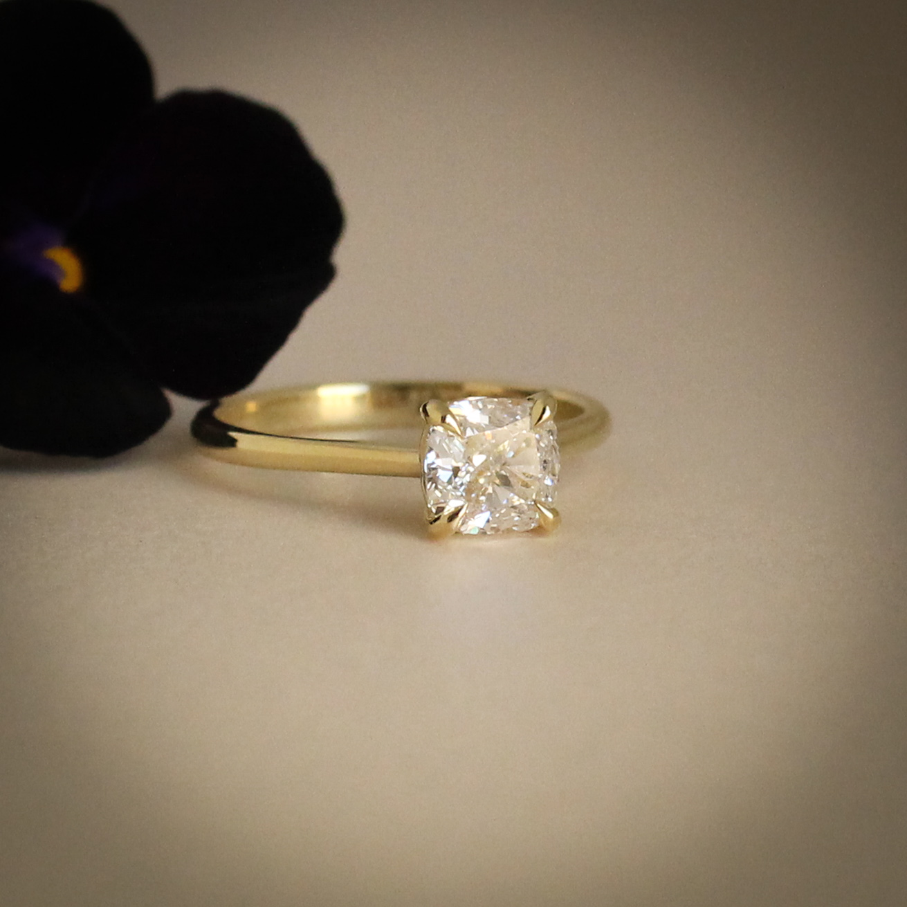 1ct cushion cut diamond engagement ring in yellow gold with hidden emerald detail