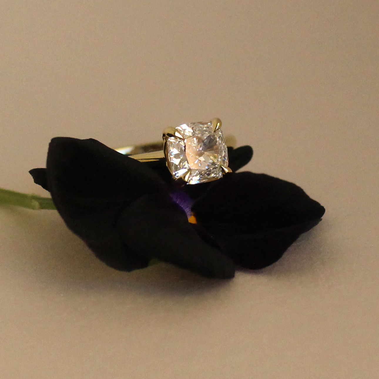 1ct cushion cut diamond engagement ring in yellow gold with hidden emerald detail
