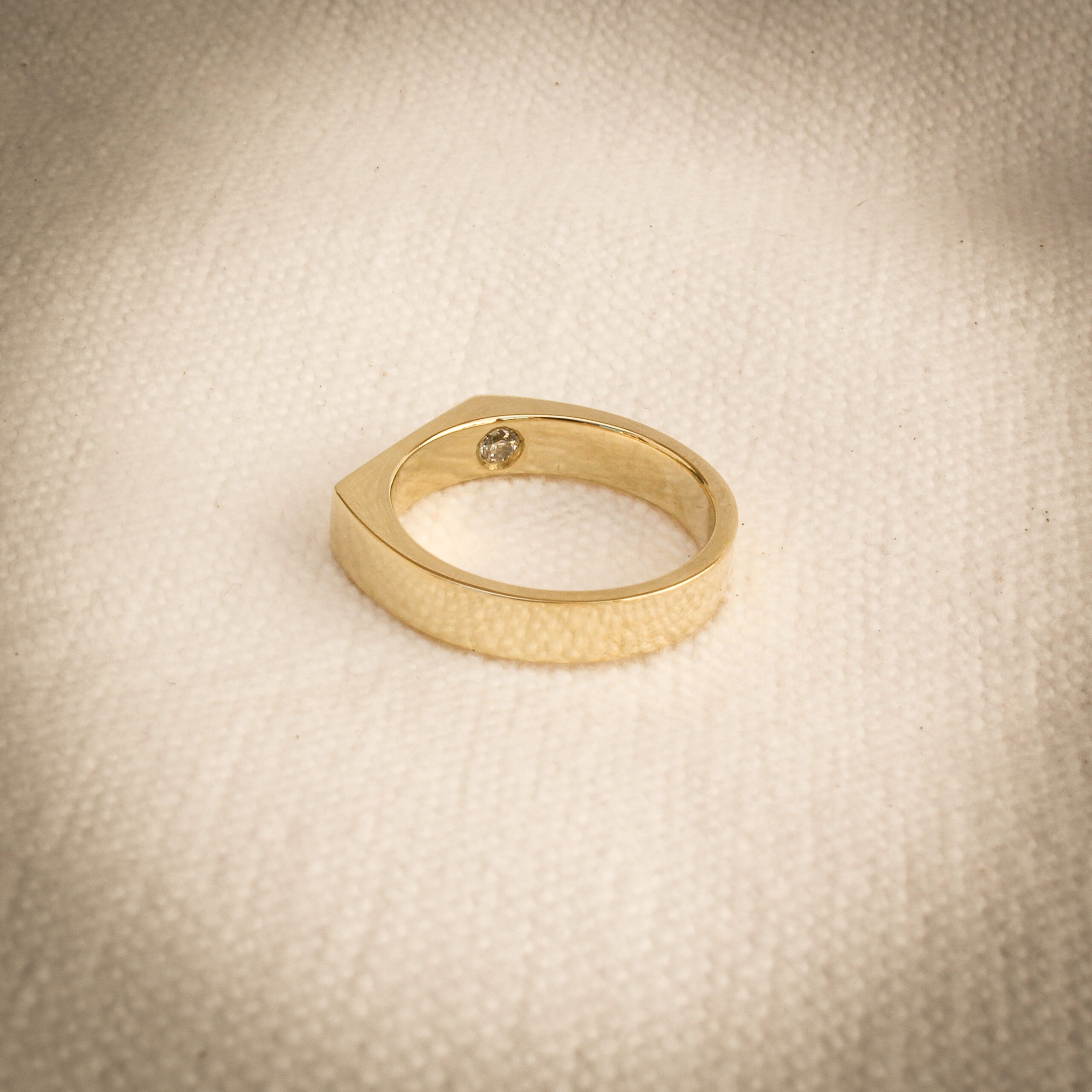 Men’s 9k yellow gold signet ring with polished face and hidden diamond detail inside the band