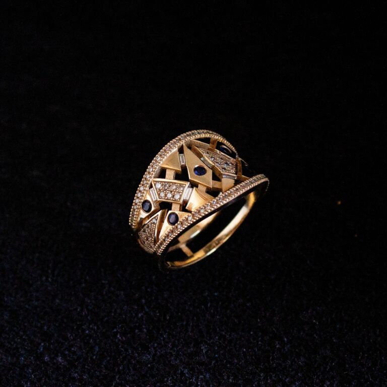 Custom 9k yellow gold ring set with repurposed diamonds and sapphires in a geometric design