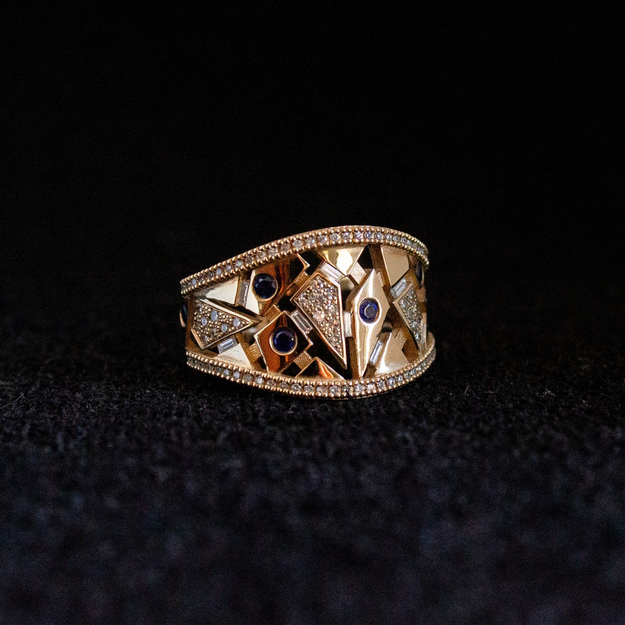 Custom 9k yellow gold ring set with repurposed diamonds and sapphires in a geometric design