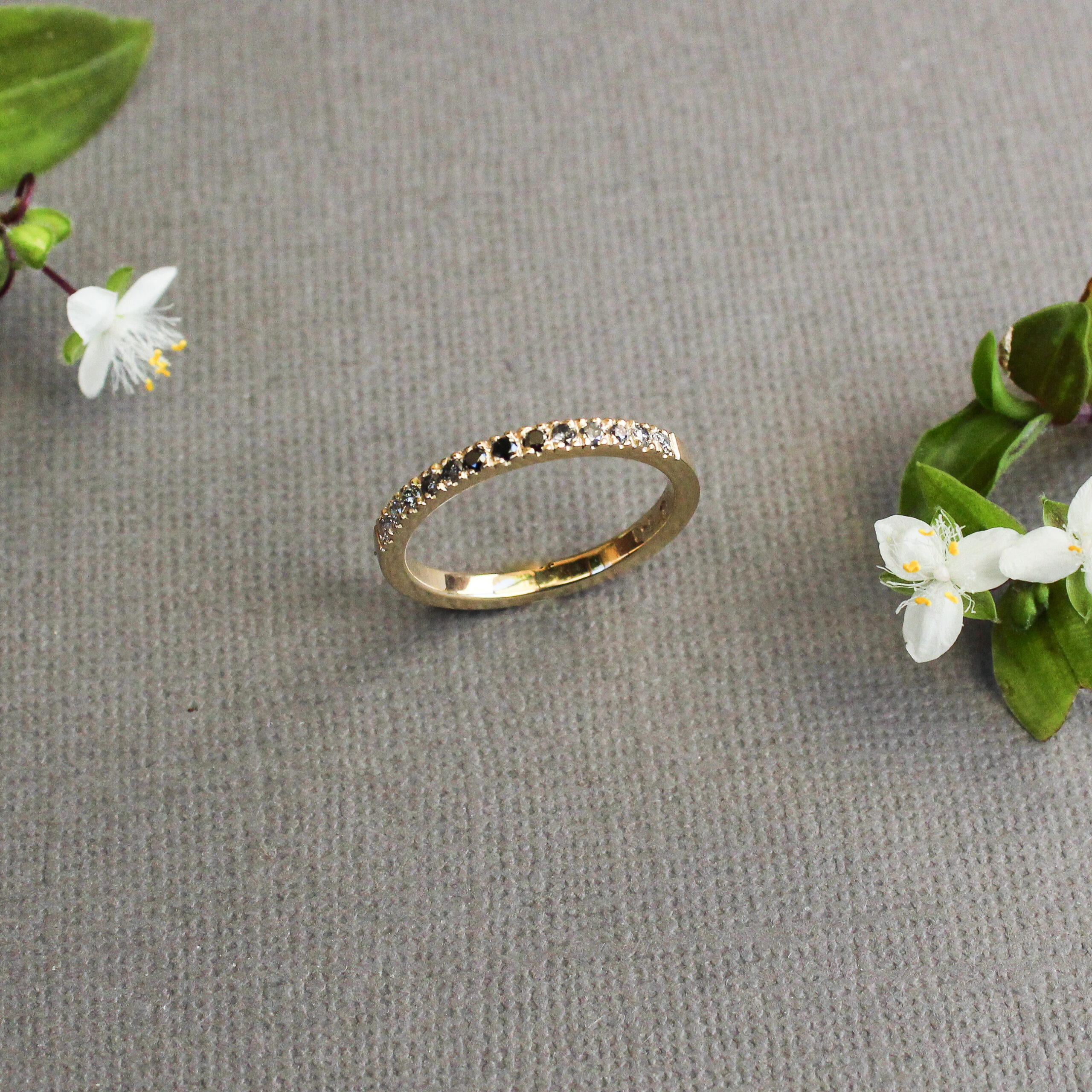 Ombre half eternity ring set with black and salt-and-pepper diamonds in a yellow gold band