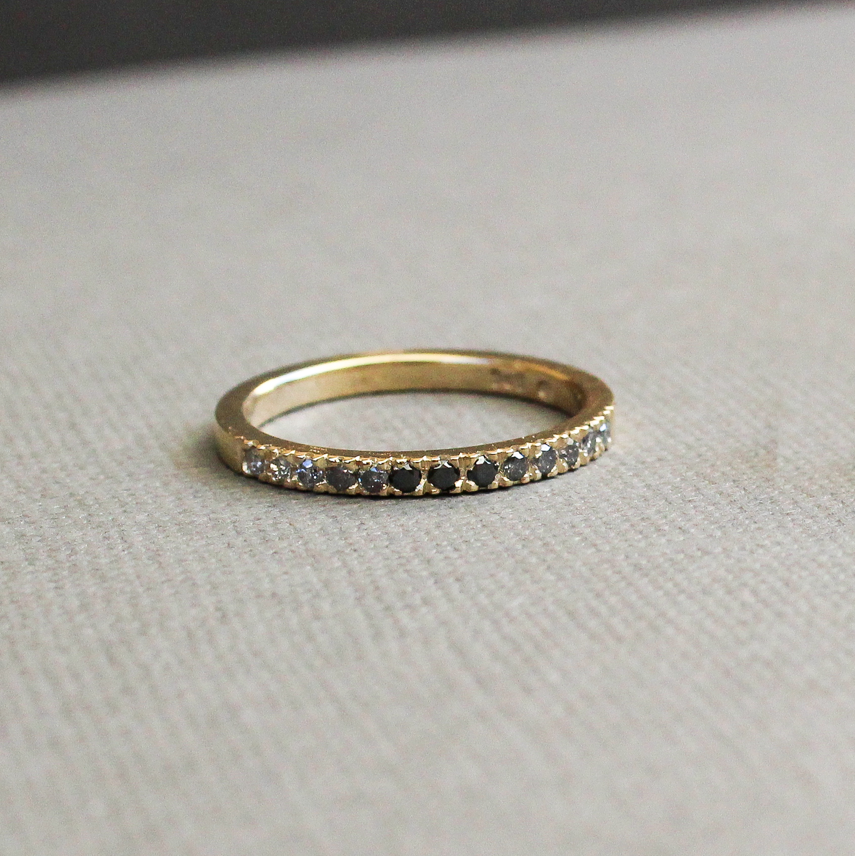 Ombre half eternity ring set with black and salt-and-pepper diamonds in a yellow gold band