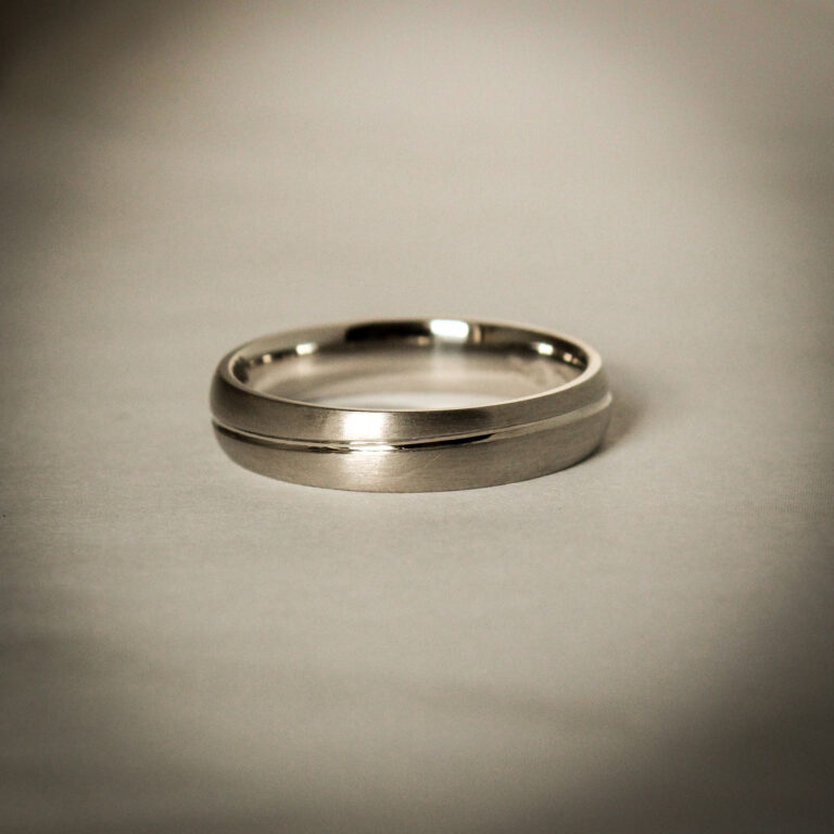 Men’s platinum wedding band with brushed finish and polished centre line detail