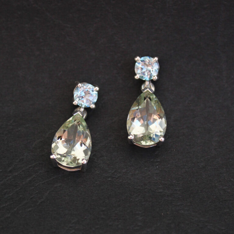 Silver drop earrings set with pear-shaped prasiolite and round blue topaz gemstones