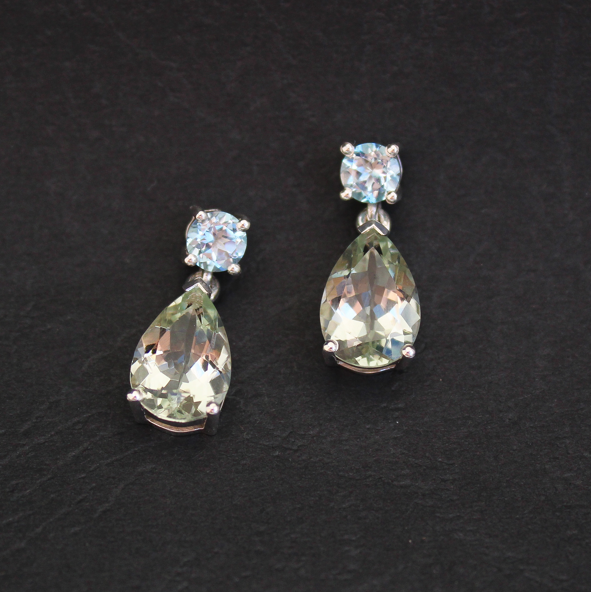Silver drop earrings set with pear-shaped prasiolite and round blue topaz gemstones
